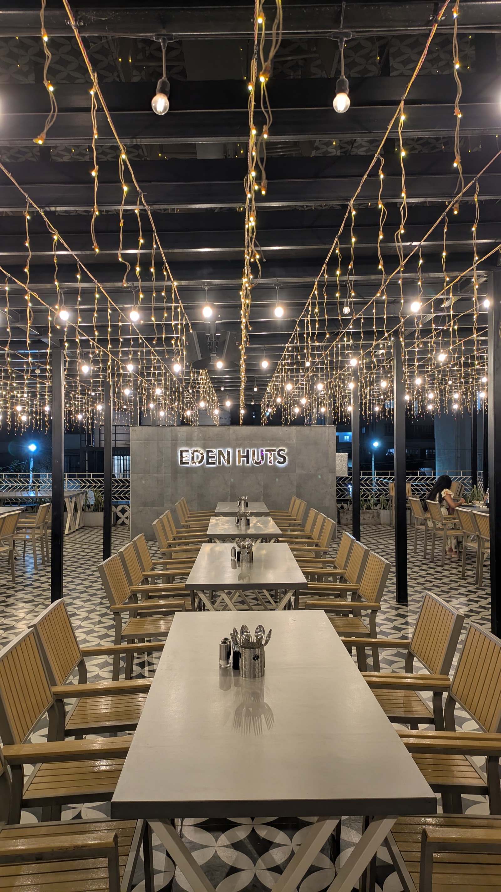 Eden Huts rooftop dining hall beneath a canopy of fairy lights